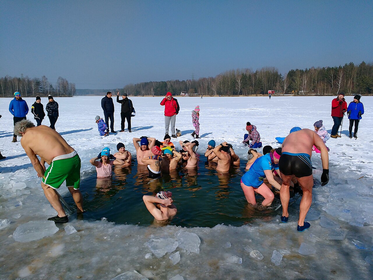 Ice can form across the top of a lake when the water freezes but there is usually still liquid water beneath. Some people go swimming in the freezing water for fun!